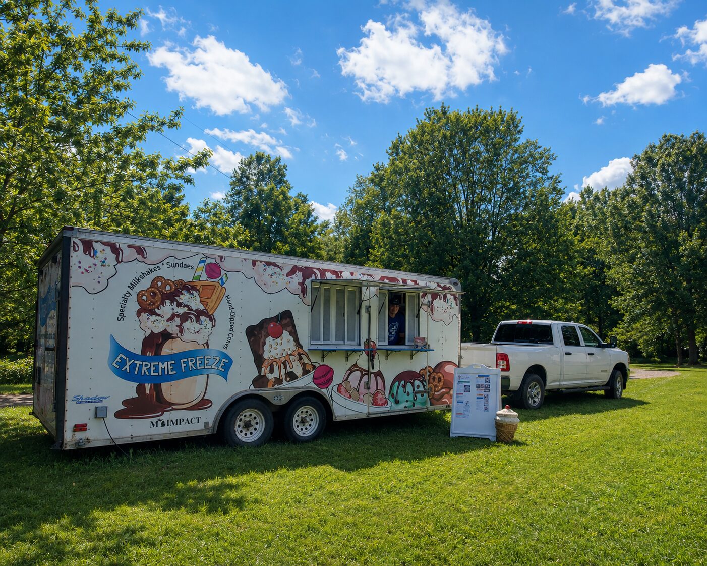 ChatGPT Image Jun 23, 2026, 06_42_22 PM The Extreme Freeze ice cream trailer, a MI-IMPACT young entrepreneur's business, set up in a park