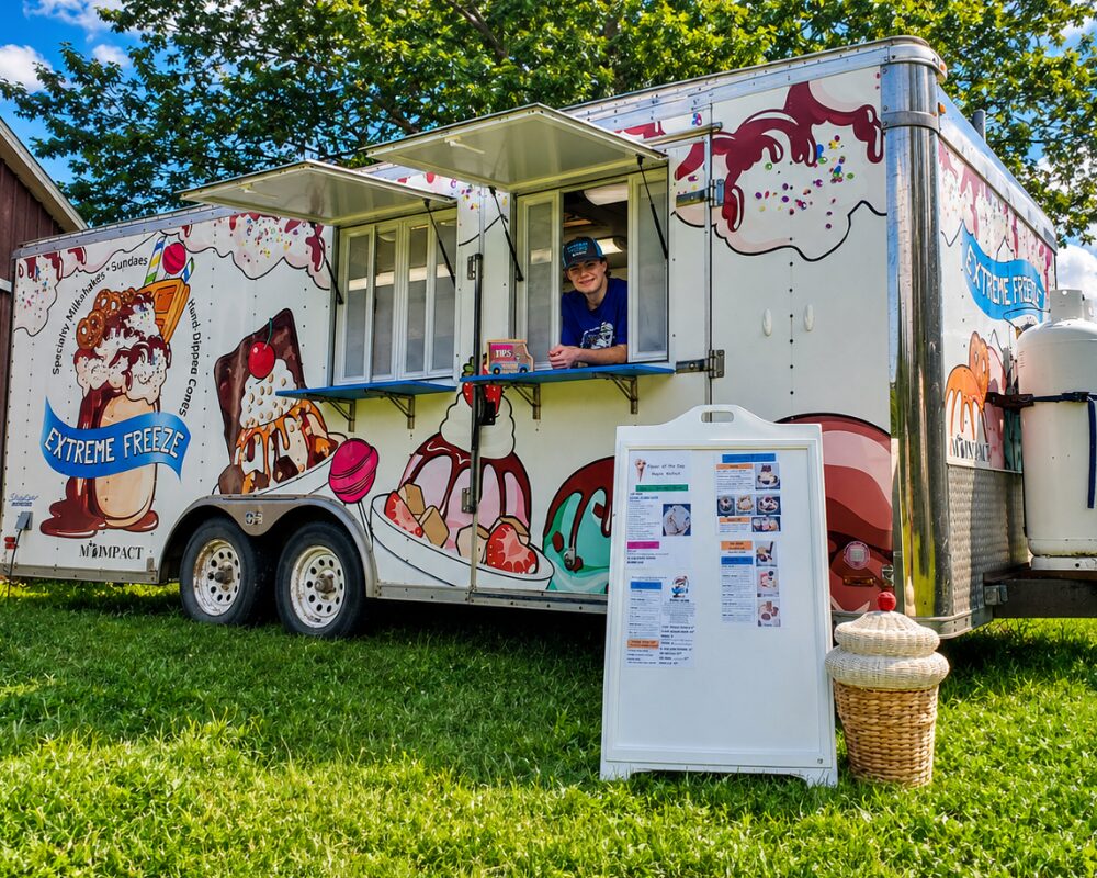 Young entrepreneur beside his ice cream truck at a MI-IMPACT Kidpreneur contest in Detroit