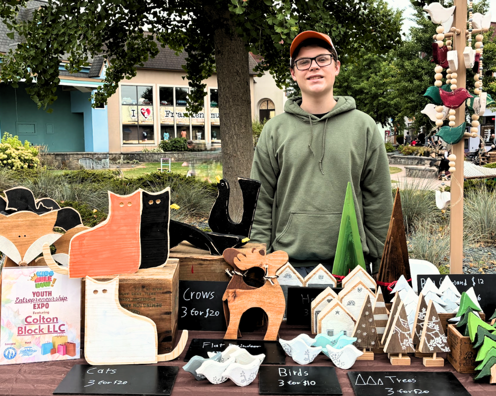 Kidpreneur-2.0-Boy-Standing-At-Seller-Table-Booth-Art-Home-Decor-Young-Entrepreneur-Events-Detroit Boy at his art and home decor stall during MI-IMPACT Kidpreneur 2.0 in Detroit