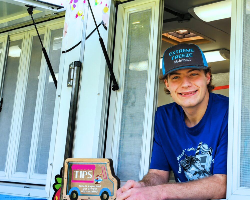 boy looking out window of food truck young entrepreneurs competition detroit michigan MI IMPACT Boy looking out of his food truck window at a MI-IMPACT young entrepreneurs competition in Detroit